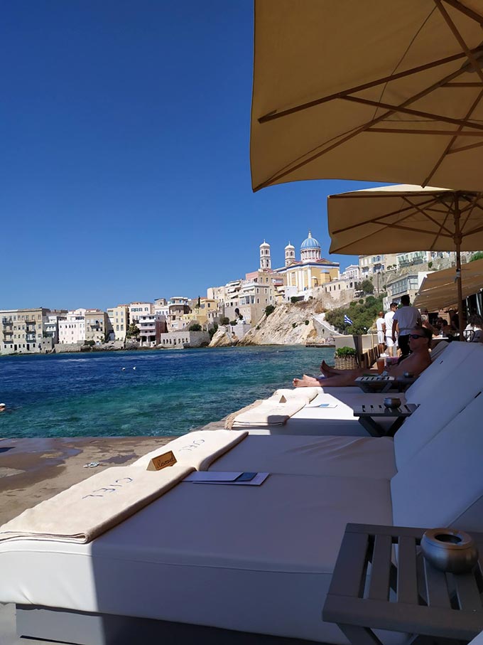 View of the district of Vaporia in Hermoupolis from a beach bar's sunbeds.