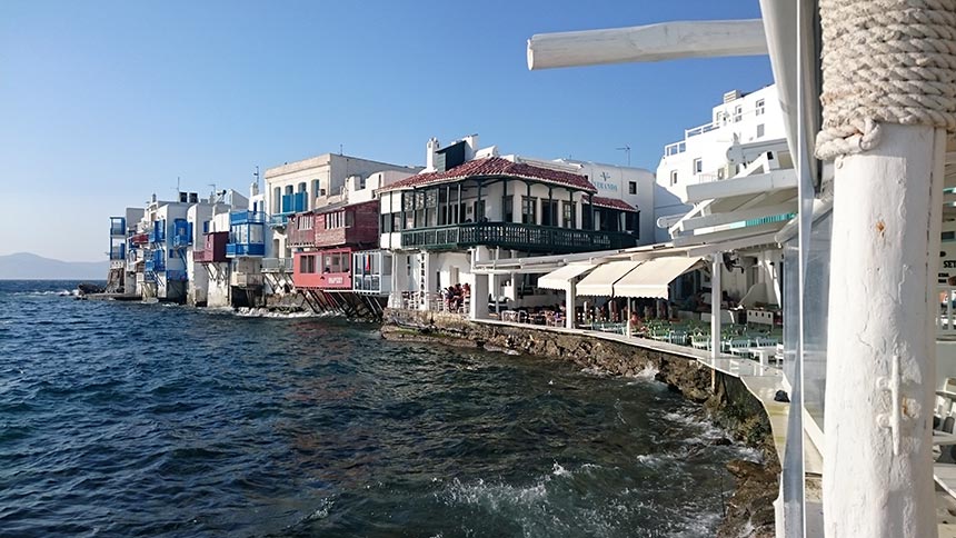 Building facades on the water front in Mykonos, known as Little Venice. Image by Velvet Karatzas.