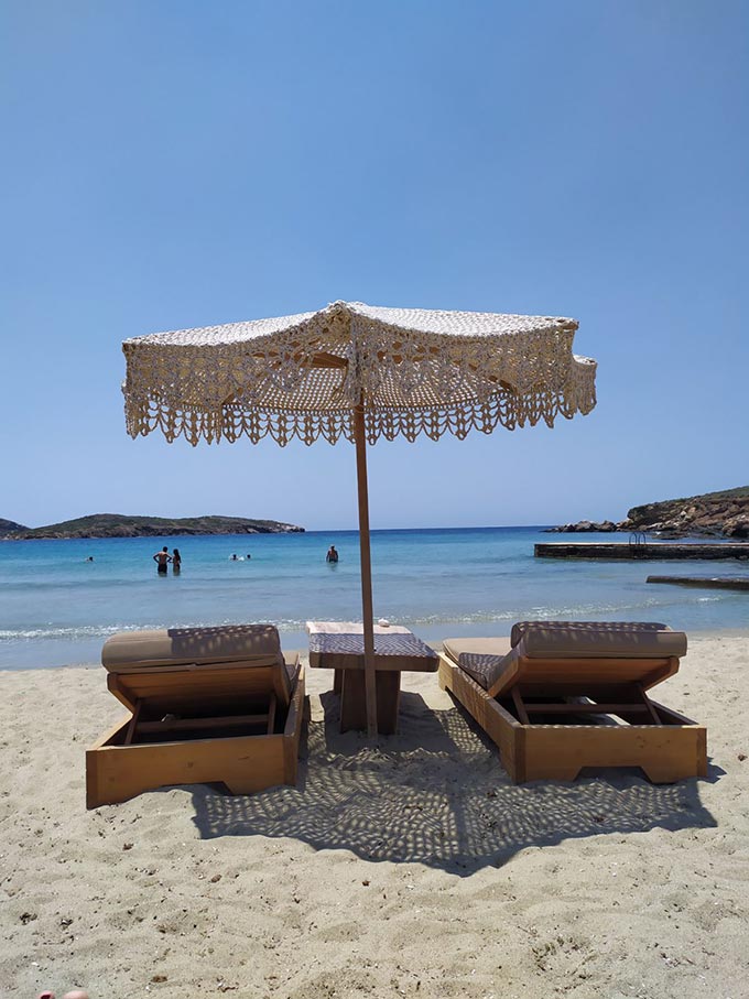 A set of sunbeds and a beach umbrella at Ono - Agathopes, Syros.