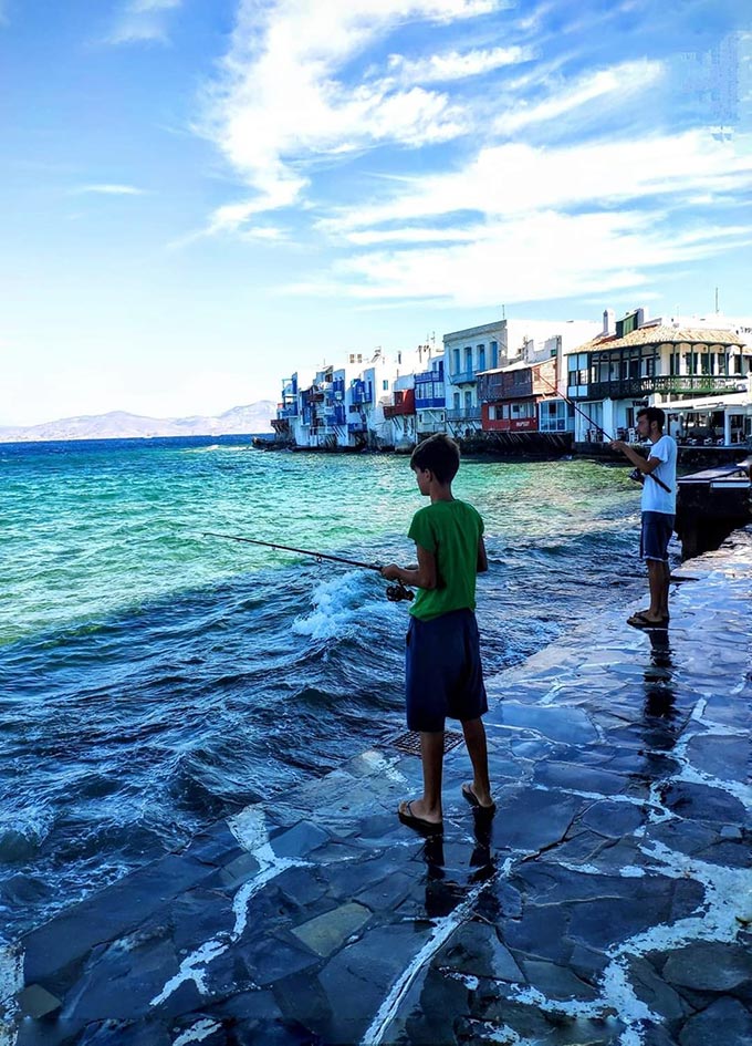 Two kids fishing near Little Venice, Mykonos.