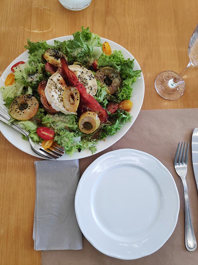 A salad with mixed vegetables, goat cheese and pear slices as served at Perroquet Tranquille.