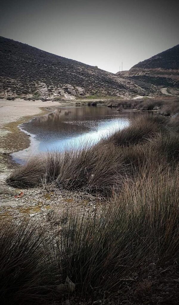 A small valley with a small body of water in Mykonos.