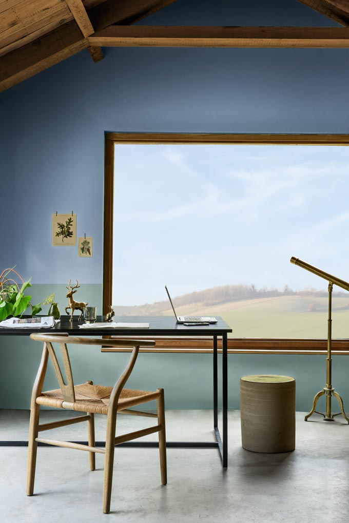 A very bright working space with an organic vibe and blue hues on the wall from Dulux - featuring the color of the year 2022 Bright Skies. Image credit: Dulux.
