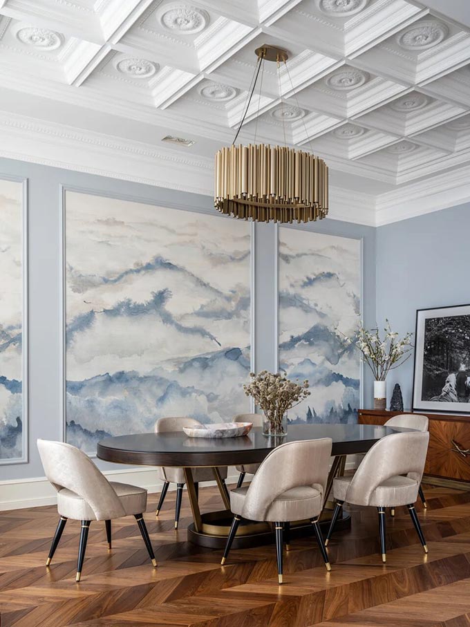 A luxurious dining space with a mid-century inspired dining chair. The walls feature a color like Dulux's Bright Skies - color of the year 2022. Image: Essential Home.