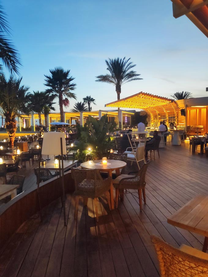 A view of the outdoor dining space of a restaurant by the sea in Voula.