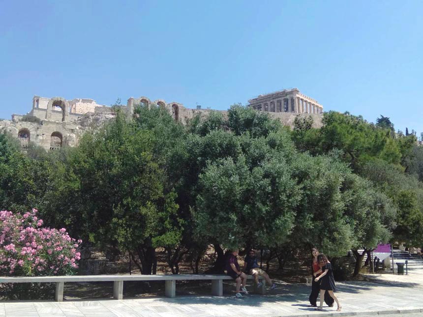 Two women walking up Areopagitou street in Athens. In the background the Acropolis can be discerned.