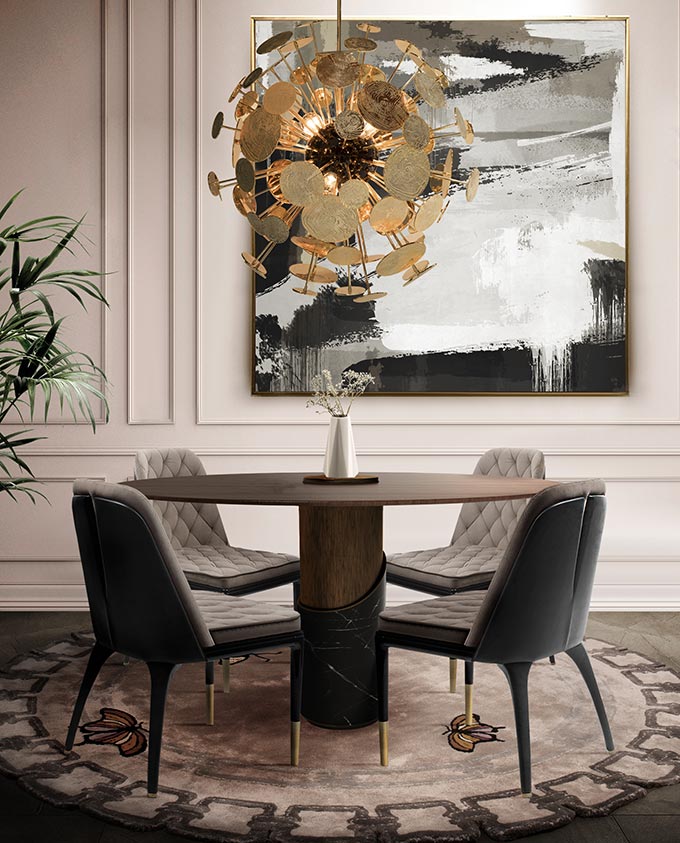 A sophisticated and elegant dining room with a round dining table and a statement pendant light featured against a beige wall backdrop. Via Caffe Latte.