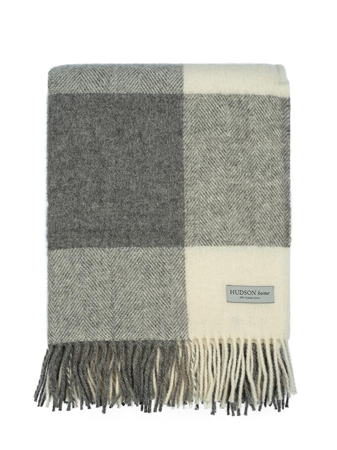 A wool throw in neutral tones with a check pattern by Hudson Home.