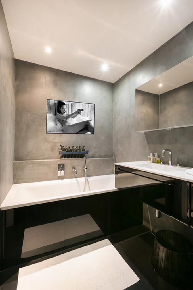 A contemporary minimal bathroom with microcement walls. Image: Boca do Lobo.