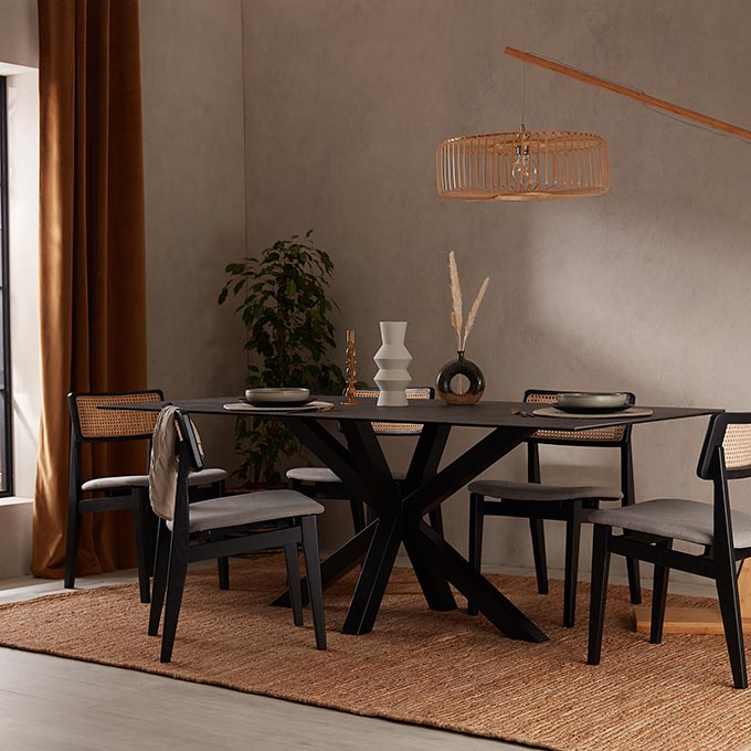 A black dining table in a brown toned dining room setting, inspired by the Japandi interior design trend. Image: Cult Furniture.