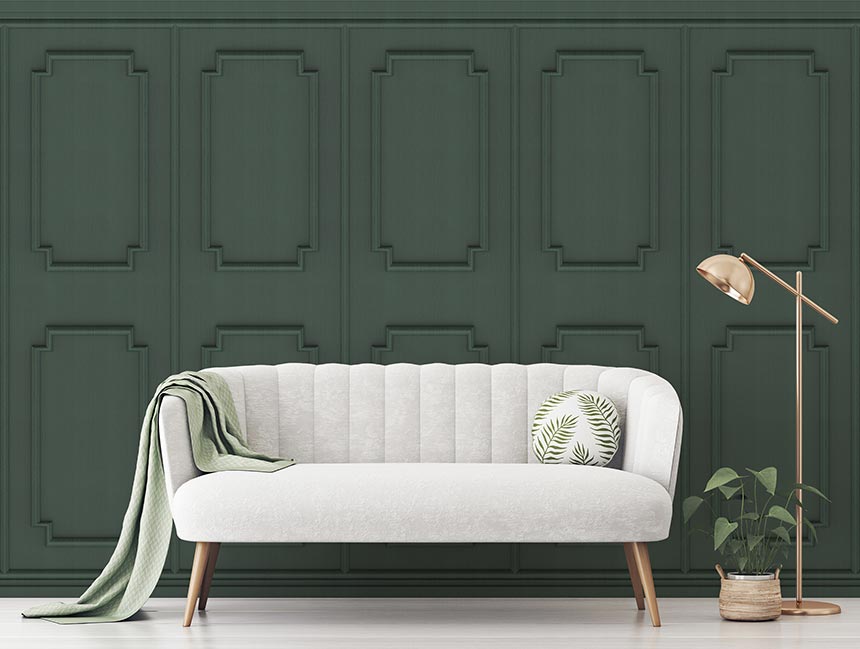 'If you can't make it, then fake it!" A lifestyle shot of a light grey sofa in front of a dark green paneling wallpaper. Image: Wallsauce.