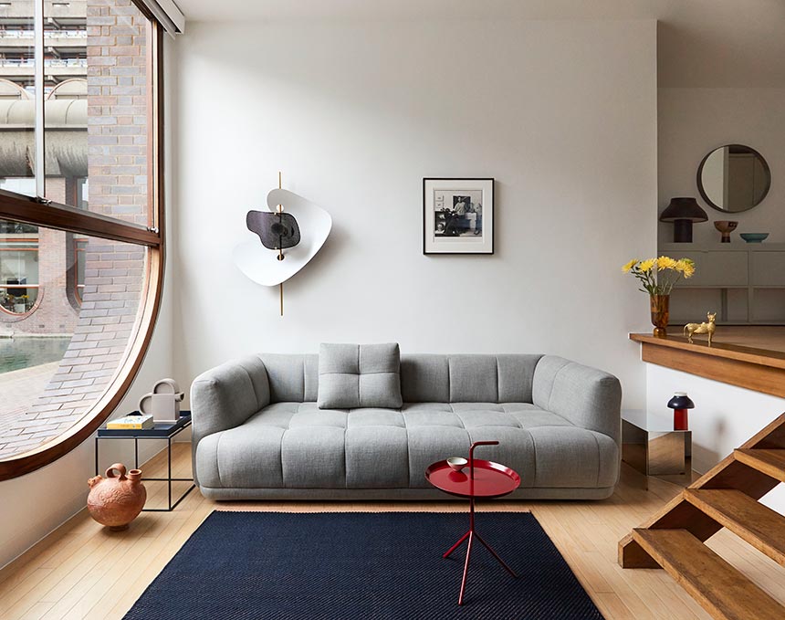 A contemporary Scandi setting with splashes of color featuring among other things the Quilton 3 seater in grey. Image: HAY.