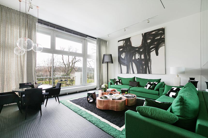 A stylish living and dining room overlooking at the garden views of Jardin de Luxembourg, in Paris. Image: Boca do Lobo.