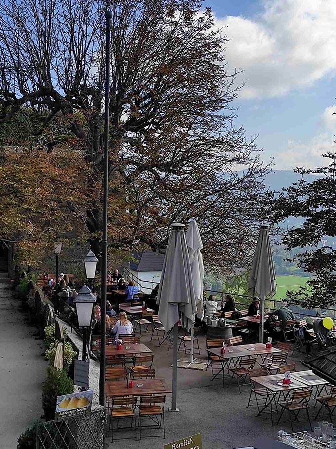 Outdoor dining setups at a scenic place in Salzburg.