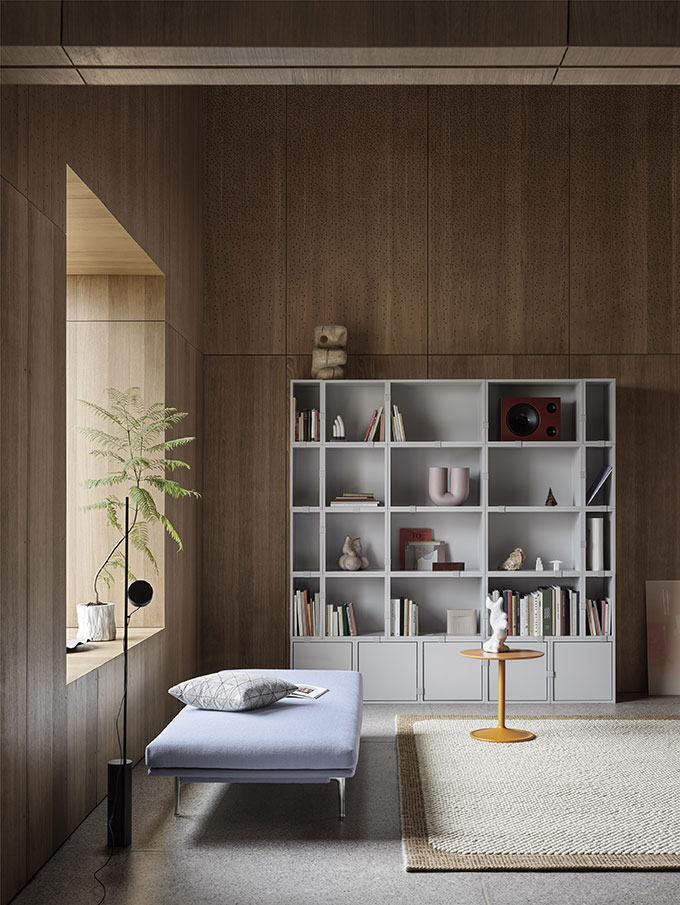 A Scandi chic space featuring a bookcase, a daybed, a minimal floor lamp and a plant by the window - some of the mindful decor elements required. Image: Muuto.