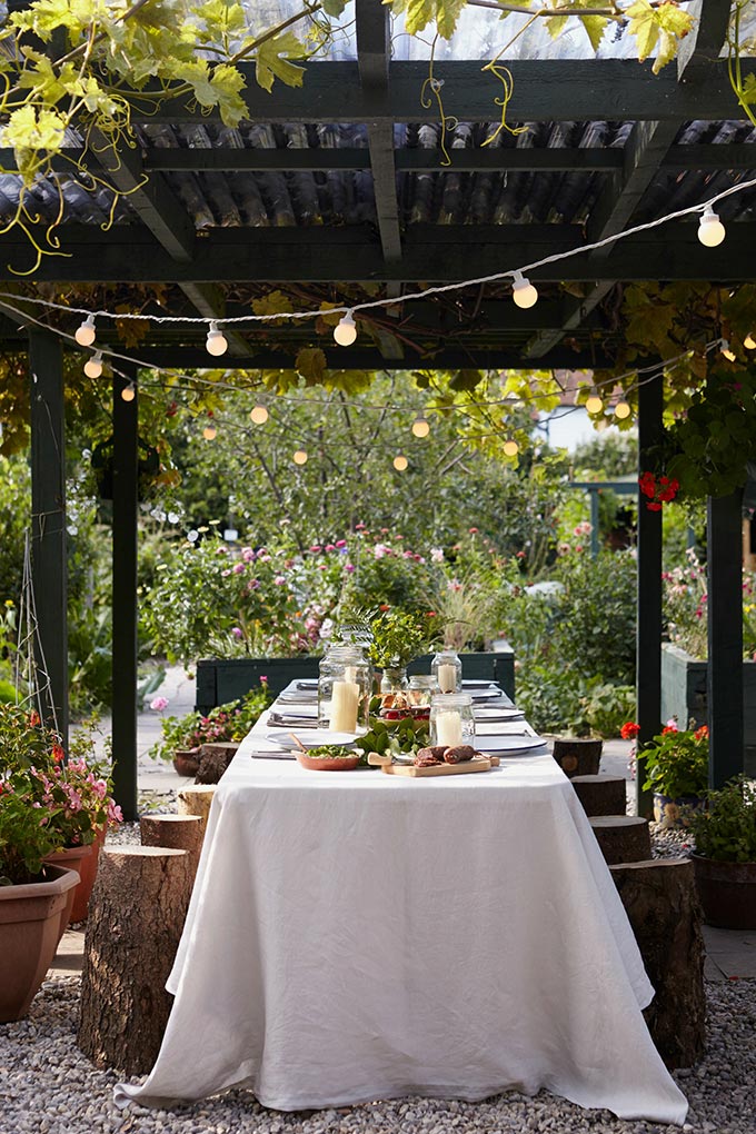 A beautiful garden setting for alfresco dining with a canopy and the Festoon lights making it merry and bright. Image: Lights4fun.co.uk.