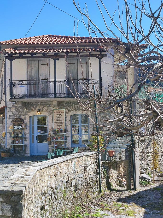 A typical traditional stone house with a shop on the ground level.