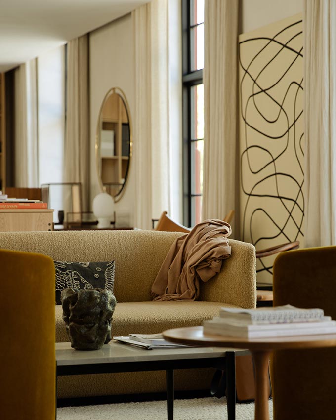 A lifestyle image of a sitting room in warm earth tones featuring a sofa and the Septembre Coffee Table. Image: MENU.