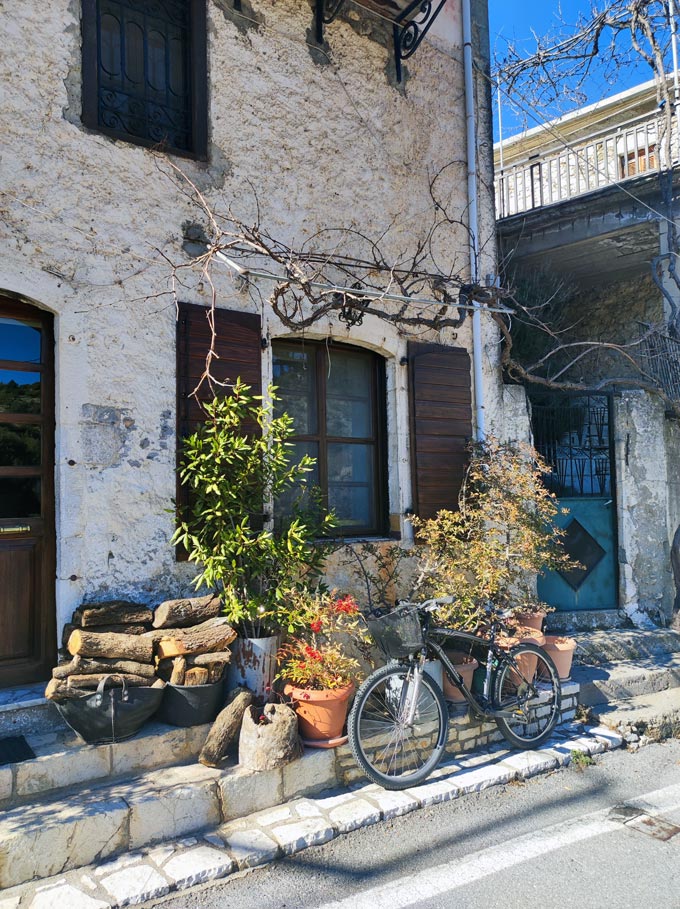 A bicycle in front of a traditional stone house.