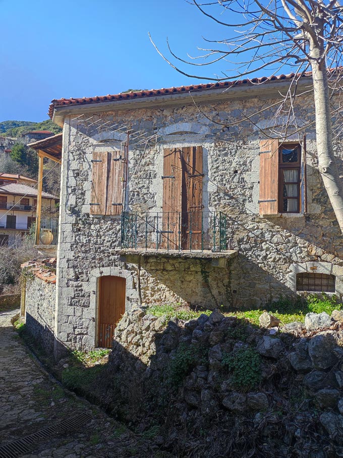 A traditional old stone house and stone paved alley in Stemnitsa.