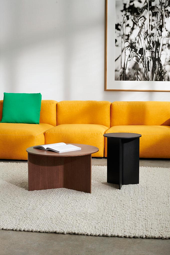 A bright yellow sofa with a bright green pillow - dopamine dressing a space, featuring the HAY slit table! Image: Nest.co.uk.