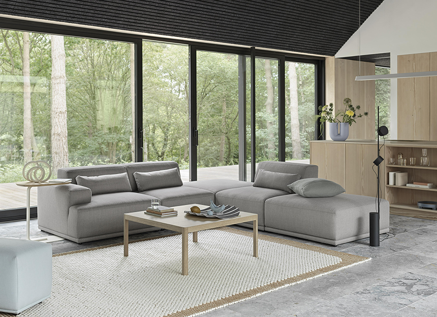 A lifestyle image of a living room with a grey sectional sofa and the Muuto Workshop Coffee Table. Image: Nest.co.uk.