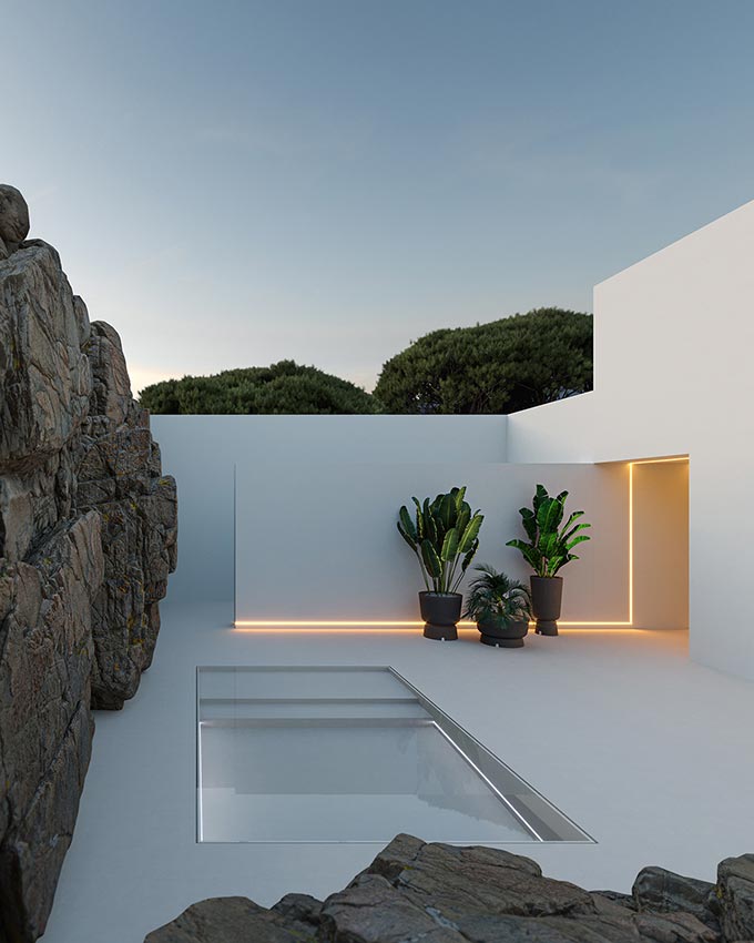 A super contemporary all white outdoor space with planters standing out and softening the rugged look of the contrast between the white manmade structure and the textured rock wall. Image: MyFace.