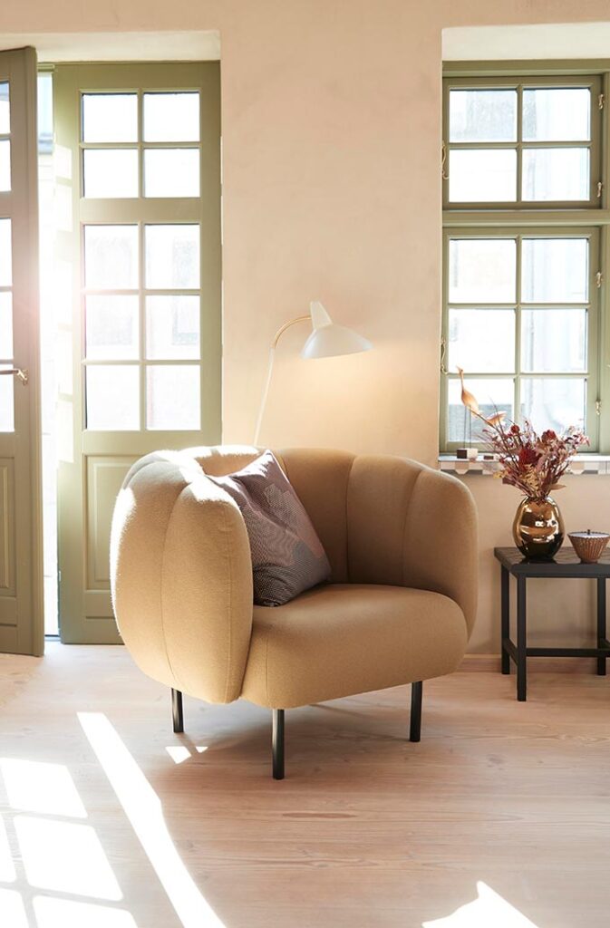 The Warm Nordic Cape Lounge chair with its scalloped design surely looks comfy in a sun flooded room with green toned windows. Image: Nest.co.uk.