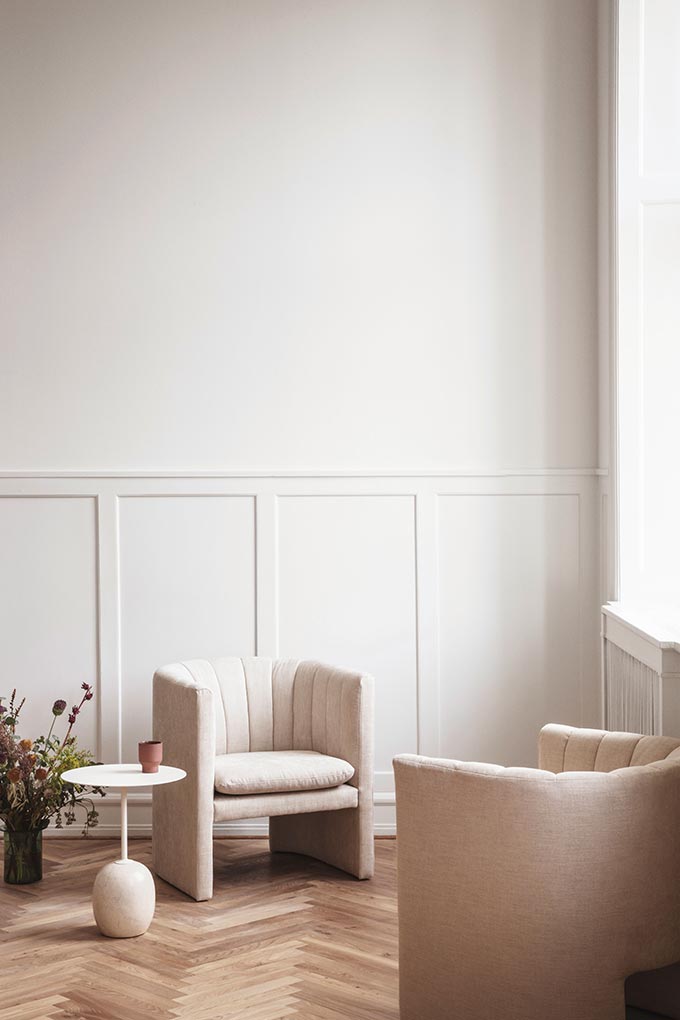 A serene, swoon-worthy vignette with two creamy club chairs from &Tradition next to a window. Image: Nest.co.uk.