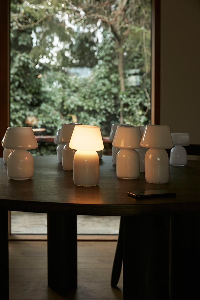 A lifestyle image featuring a bunch of the Apollo portable table lamps on a table. Image: HAY.