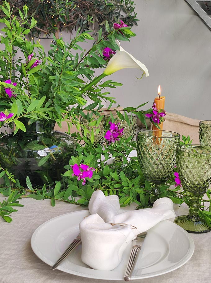 Partial view of an Easte tablescape with the centerpiece vase showing.