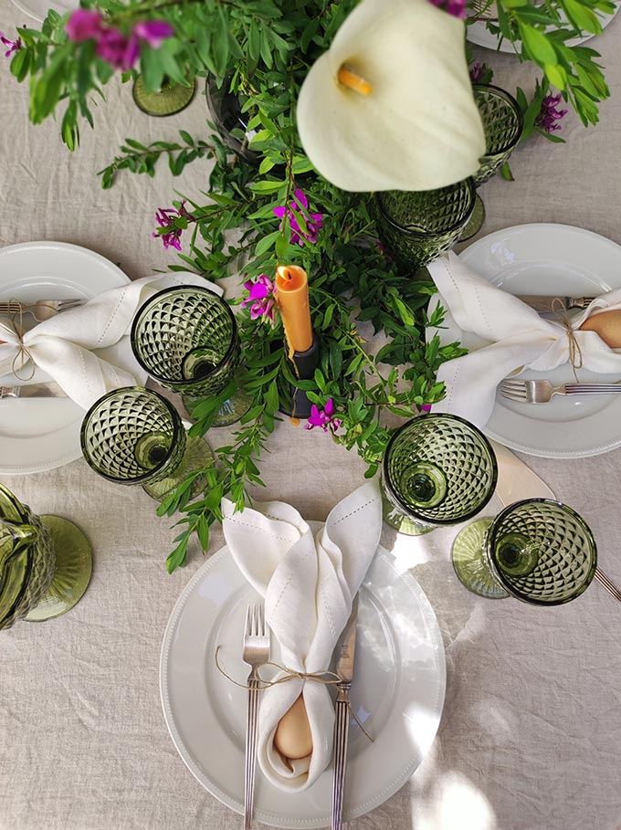 Three of the six settings shown from above of a dining setting for Easter lunch.