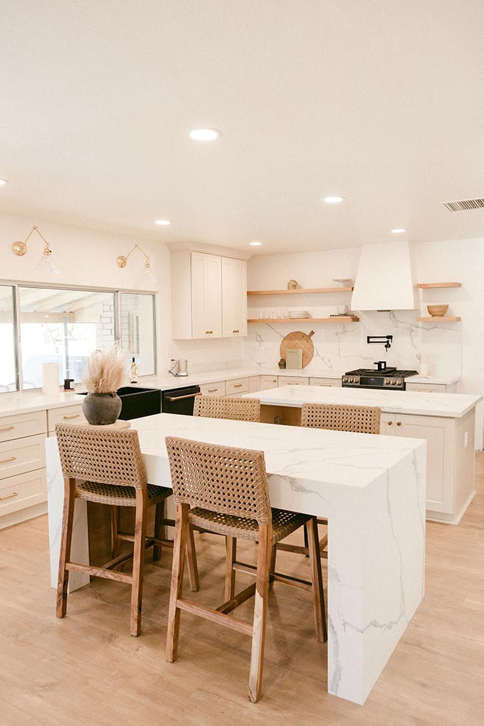 A white contemporary kitchen with double kitchen islands - one of the worse interior design trend pitfalls.