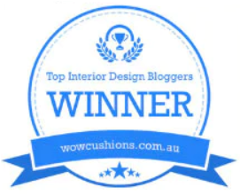 A press award badge for Top Interior Design Bloggers from wowcushions.com.au.