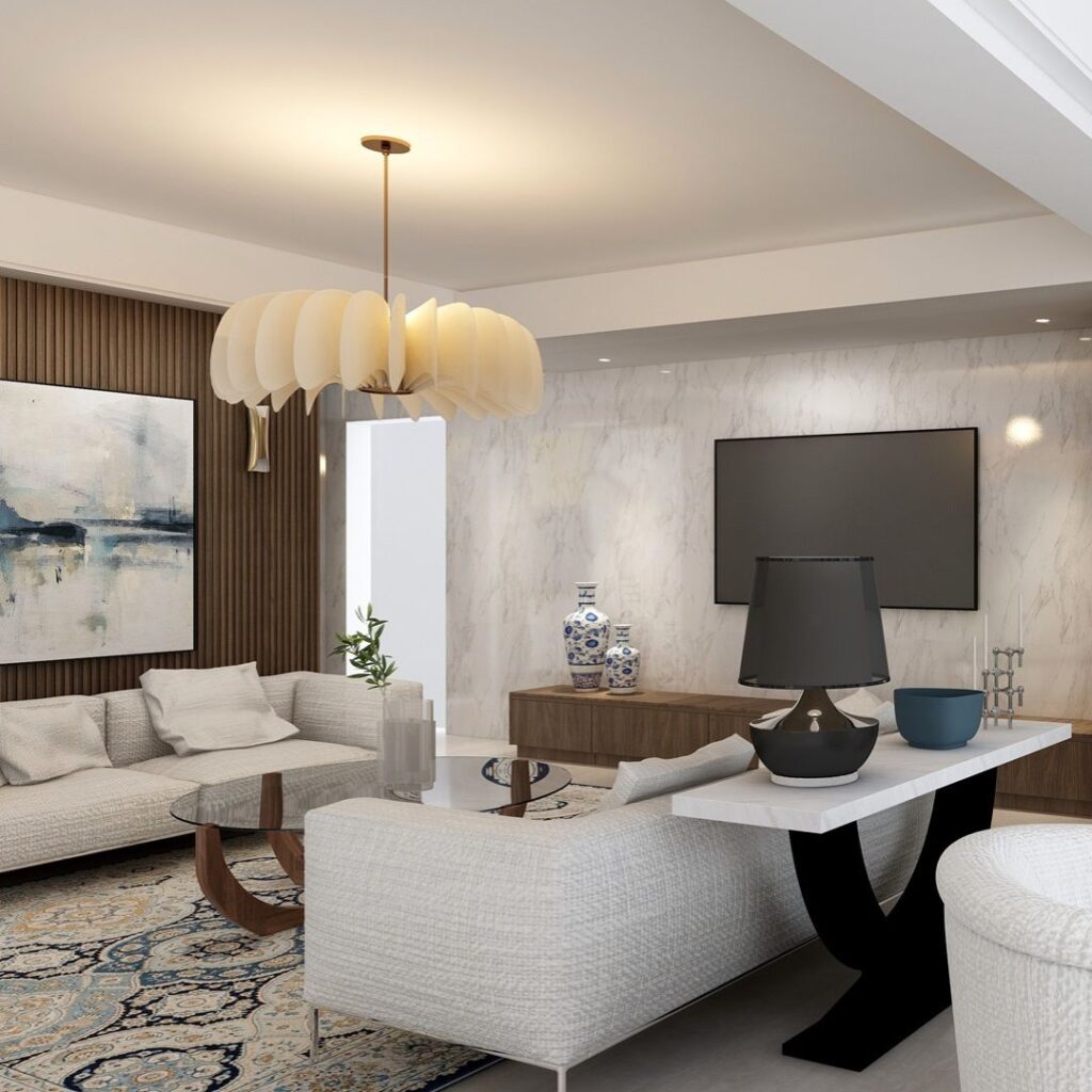 Inside view of a contemporary open plan living room with off-white sofas, Calacatta marble TV wall unit, travertine stone flooring and Persian rugs. Image copyright: Velvet Karatzas IDA.